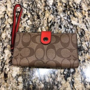 Coach signature wristlet that holds a phone